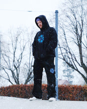 Load image into Gallery viewer, Man wearing oversized Bubbles Hoodie and Oversized black Bubbles Cargos In the snow