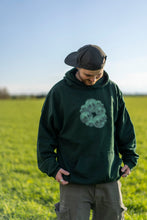 Load image into Gallery viewer, Man wearing oversized green tree of life hoodie with green cargos while smiling in a grass field