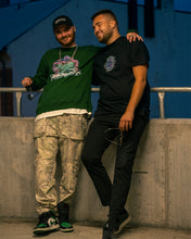 Load image into Gallery viewer, man wearing black roboflower dad hat cap with green roboflower v3 sweater
