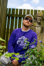 Load image into Gallery viewer, man wearing classy eye bubbles purple sweater around lavender flowers