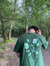 Load image into Gallery viewer, man with cap wearing green fly outside the jar butterfly t-shirt back graphic