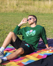 Load image into Gallery viewer, man wearing green misfit painted sweater with black misfit painted shorts and sunglasses while in the sun