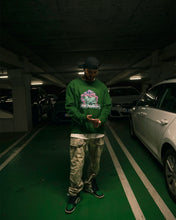 Load image into Gallery viewer, man wearing green oversized roboflower v3 graphic floral sweater with green jordan 1
