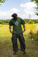 Load image into Gallery viewer, man wearing military green oversized magic mirror graphic t-shirt with green oversized roboflower cargos
