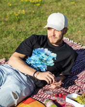 Load image into Gallery viewer, man wearing oversized black lifted living t-shirt  at a picnic