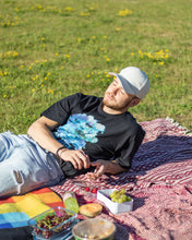 Load image into Gallery viewer, man wearing oversized black lifted living t-shirt  at a picnic 2