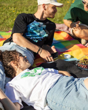 Load image into Gallery viewer, man wearing oversized black lifted living t-shirt with woman wearing white misfit tee