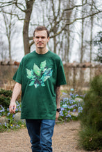 Load image into Gallery viewer, man wearing oversized green roboflower graphic t-shirt