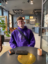 Load image into Gallery viewer, man wearing oversized purple graphic hoodie with shoulder bag