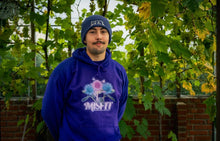 Load image into Gallery viewer, man wearing oversized purple misfit v2 floral graphic hoodie with purple DFKT logo beanie