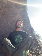 Load image into Gallery viewer, man wearing oversized roboflower cargos with black bubbles t-shirt while sitting in the sun