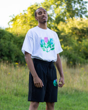 Load image into Gallery viewer, man wearing oversized white misfit painted t-shirt in grass field