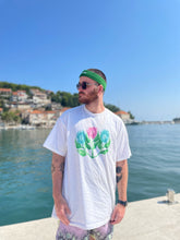 Load image into Gallery viewer, man wearing white misfit painted t-shirt with green halara headband