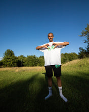 Load image into Gallery viewer, man wearing white oversized misfit t-shirt and black misfit painted shorts while smiling