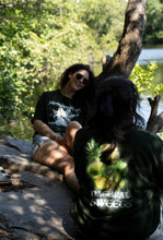 Load image into Gallery viewer, woman wearing green oversized DFKT Fruits t-shirt by the lake