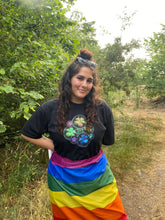 Load image into Gallery viewer, woman wearing oversized black rainbow bubbles pride t-shirt while wearing pride flag as a skirt