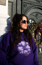 Load image into Gallery viewer, woman wearing purple oversized love bubbles valentines hoodie with sunglasses