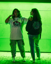 Load image into Gallery viewer, women wearing oversized white rovoflower v3 t-shirt and black roboflower v2 sweater with back graphic showing in greenlight