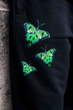 Load image into Gallery viewer, black ripped butterfly sweatpants graphic closeup