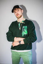 Load image into Gallery viewer, man wearing a green oversized think outside the jar cozy fit sweater