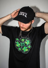 Load image into Gallery viewer, man wearing black DFKT logo dad hat cap with black bubbles graphic t-shirt