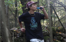 Load image into Gallery viewer, man wearing black mindliquid graphic t-shirt while drinking blue liquid