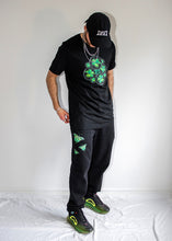 Load image into Gallery viewer, man wearing black ripped butterfly sweatpants with oversized black bubbles t-shirt and black DFKT logo dad hat cap