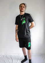 Load image into Gallery viewer, man wearing black think outside the jar t-shirt and black think outside the jar shorts