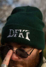 Load image into Gallery viewer, man wearing green DFKT logo beanie, graphic closeup