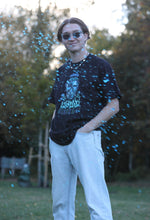 Load image into Gallery viewer, man wearing oversized black mindliquid graphic t-shirt while blue liquid is splashing