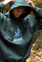 Load image into Gallery viewer, man wearing oversized green mindliquid graphic hoodie with hood up, hoodie closeup