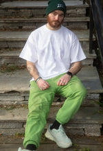 Load image into Gallery viewer, man wearing white oversized thinker graphic t-shirt with green DFKT logo beanie