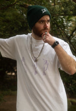 Load image into Gallery viewer, man wearing white oversized thinker graphic t-shirt with green DFKT logo beanie with apple watch