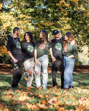 Load image into Gallery viewer, men and women wearing black bubbles graphic t-shirts and green oversized stress graphic t-shirts