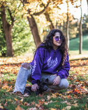 Load image into Gallery viewer, woman wearing an oversized purple lavender hoodie with ripped jeans while petting dog