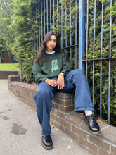 Load image into Gallery viewer, woman wearing oversized graphic think outside the jar sweater with blue jeans