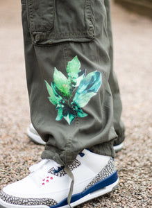 Green roboflower cargos floral graphic closeup with jordan 3s