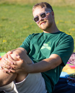 Man wearing green friends t-shirt with sunglasses