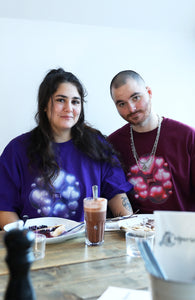 couple wearing oversized purple and red love bubbles valentines t-shirts while eating crepes