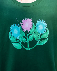 green misfit painted sweater graphic closeup