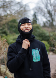 man smiling wearing black fly outside the jar graphic hoodie