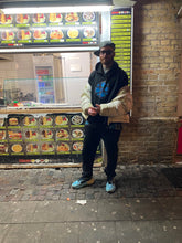 Load image into Gallery viewer, man wearing Bubbles Hoodie with blue shoes and winter jacket