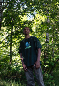 man wearing a green oversized thermal graphic overload t-shirt