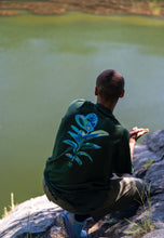 Load image into Gallery viewer, man wearing a green oversized thermal graphic overload t-shirt showing back graphic