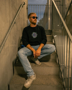 man wearing black roboflower v2 sweater in stariwell