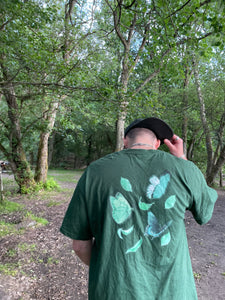 man with cap wearing green fly outside the jar butterfly t-shirt back graphic