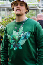 Load image into Gallery viewer, man wearing green roboflower floral sweater, flower graphic closeup