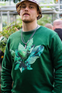 man wearing green roboflower floral sweater, flower graphic closeup