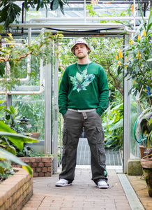 man wearing green roboflower floral sweater with oversized green roboflower cargos