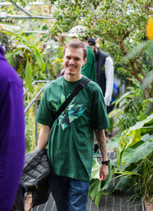 man wearing oversized green roboflower t-shirt